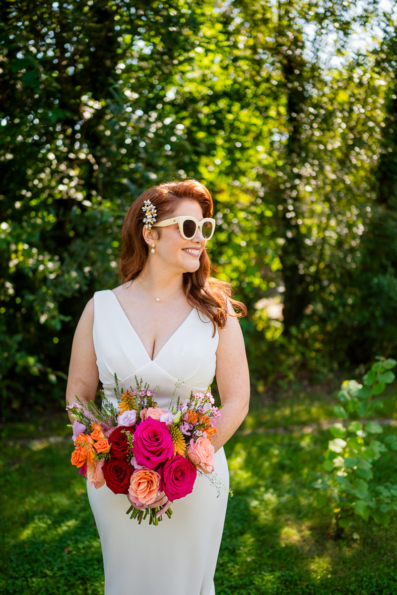 Bride wearing sunglasses and holding her wedding bouquet at Drumhierny Woodland Hideaway, Sligo