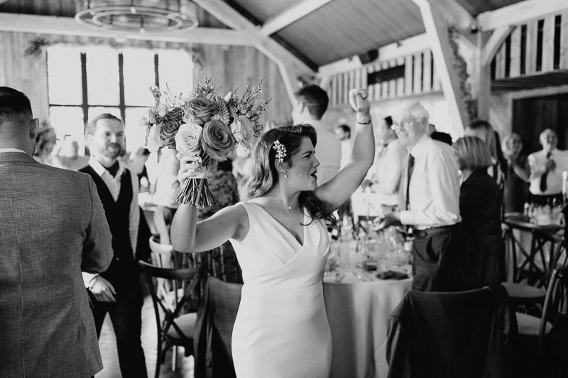 Bride and groom entering the barn as guests welcome them at Drumhierny Woodland Hideaway, Sligo
