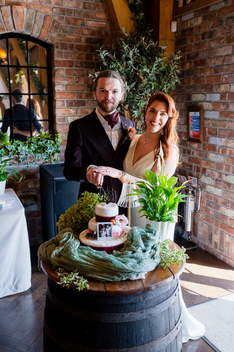 Bride and groom with their wedding cake at Drumhierny Woodland Hideaway, Leitrim